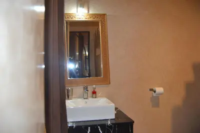 a bathroom with a white sink and a mirror at Riad Samarine in Marrakech