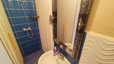 a bathroom with a shower with a sink and a mirror at Riad Abdou in Marrakech