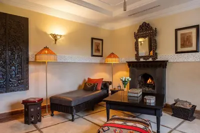 a living room with a couch and a fireplace at La Villa des Orangers - Relais & Châteaux in Marrakech
