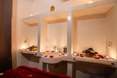 a bathroom with a sink and a counter with lights at Riad Alaka in Marrakech