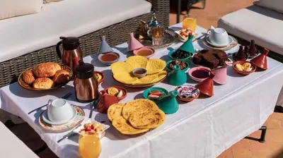 a table with breakfast foods and drinks on it at Riad Alaka in Marrakech