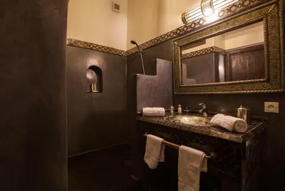 a bathroom with a sink and a mirror at Riad Alaka in Marrakech