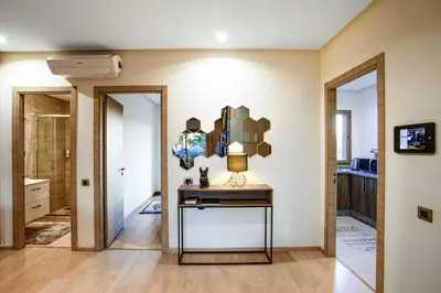 a room with a table with a lamp on it at Darkech Prestigia Luxury Apt in Marrakech