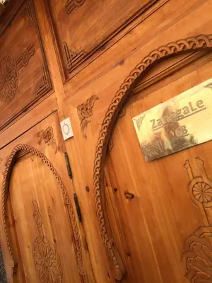 a wooden door with a mirror and a sign on it at Riad Le Marrakech Berrima in Marrakech