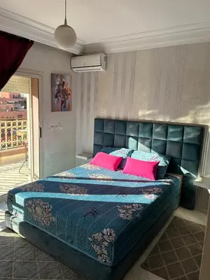 a bedroom with a large bed with pink pillows at Susana home in Marrakech