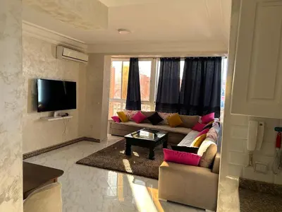 a living room with a couch and a tv at Susana home in Marrakech