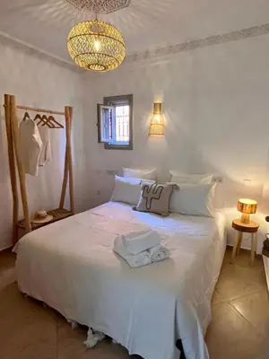 a bedroom with a white bed with towels on it at Riad M17 - Hammam & Spa in Marrakech