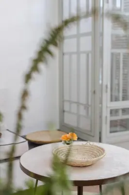 a table with a bowl of flowers on top of it at Riad M17 - Hammam & Spa in Marrakech