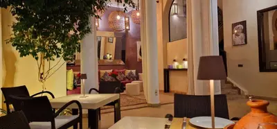 a living room with a table and chairs at Riad de Vincent in Marrakech