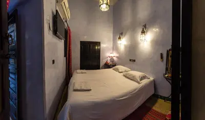 a small bedroom with a white bed in a room at Riad Omar in Marrakech