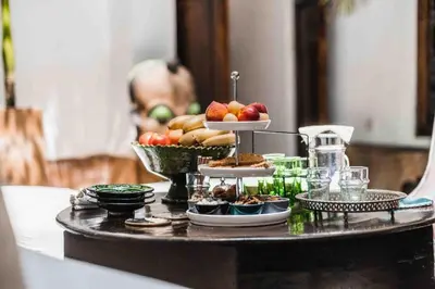 a table with a tray of food on it at Riad Wabisabi in Marrakech