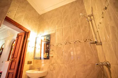 a bathroom with a shower and a sink and a sink at Riad Aymane in Marrakech