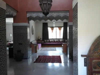 a living room with a couch and a rug at Villa clos Odette in Marrakech