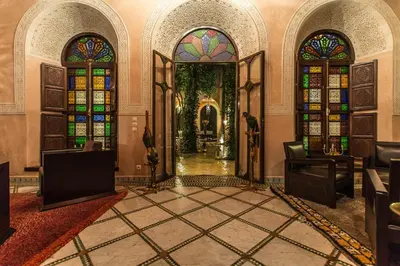 an entrance to a building with stained glass windows at Riad Le Perroquet Bleu Suites & Spa in Marrakech