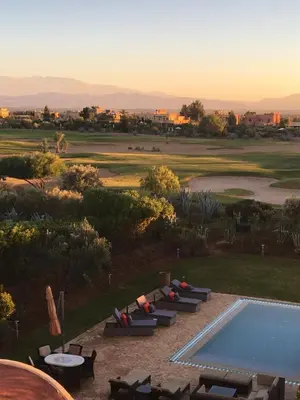 a view of a pool and a golf course at Villa entière GOLF MARRAKECH in Marrakech