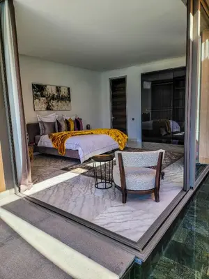 a bedroom with a bed and a couch and a table at Villa Oxygène Marrakech in Marrakech