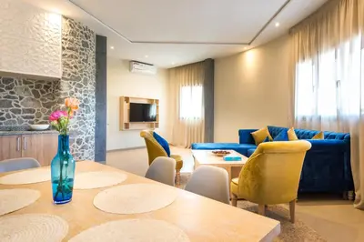 a living room with a table and a blue couch at BnB MEDINA in Marrakech