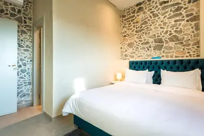 a bedroom with a large bed and a stone wall at BnB MEDINA in Marrakech