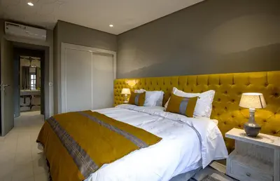 a bedroom with a large bed with a yellow headboard at BnB MEDINA in Marrakech