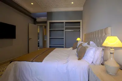 a bedroom with a large white bed and a lamp at BnB MEDINA in Marrakech