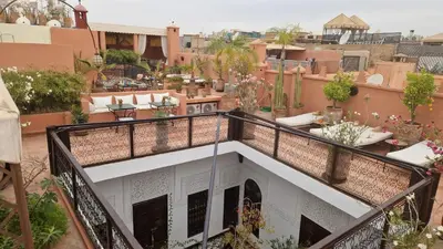 a balcony with a view of a city at Riad Les Nuits de Marrakech in Marrakech