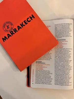 an orange book sitting on top of a book at Riad Les Nuits de Marrakech in Marrakech