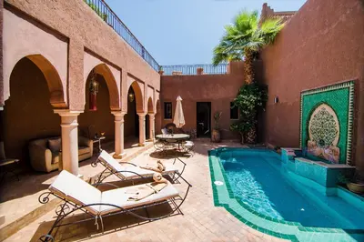 a patio with chairs and a swimming pool at Residence Dar Lamia Marrakech in Dar Caïd Layadi