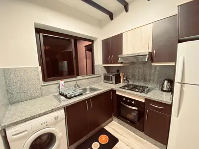 a kitchen with a sink and a stove and a dishwasher at Cosy stays central apartements , guéliz Marrakech in Marrakech