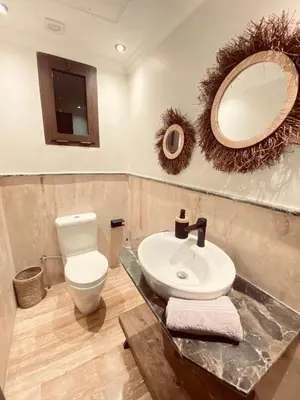 a bathroom with a sink and a toilet and a mirror at Cosy stays central apartements , guéliz Marrakech in Marrakech