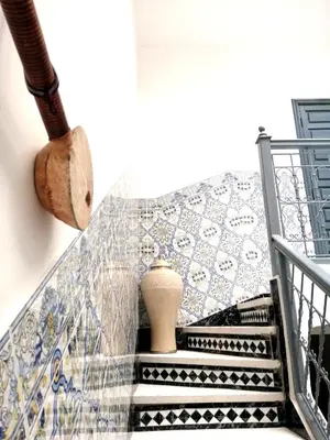 a set of stairs with a vase on it at Riad Ansar in Marrakech