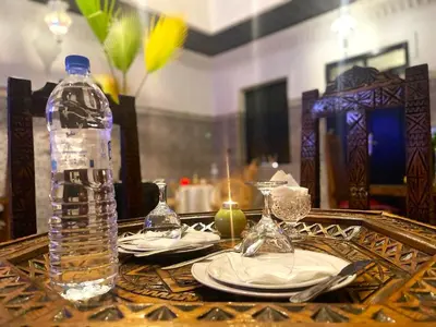 a table with a bottle of water on top of it at Riad dar Assou in Marrakech
