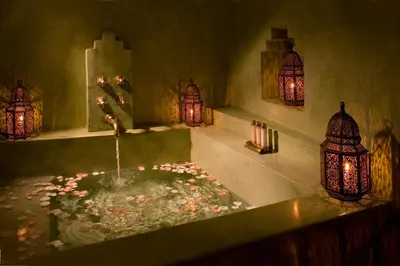 a bathroom with a bath tub with a fountain with flowers at Riad Meriem in Marrakech