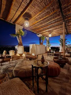 a large room with tables and couches and a table at Palais Ronsard Relais & Chateaux in Marrakech