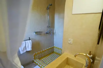 a bathroom with a sink and a shower at Riad Le Limoun and Spa in Marrakech