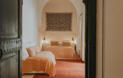 a bedroom with two beds and a couch at Dar El Qadi in Marrakech