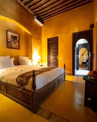 a bedroom with a large bed in a room at Dar Les Cigognes in Marrakech
