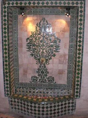 a tile wall with a picture of a tree on it at Riad Hiba in Marrakech