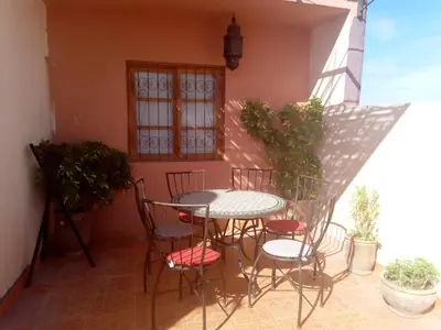 a patio with a table and chairs on a balcony at Marrakech autrement in Marrakech