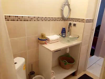 a small bathroom with a sink and a mirror at Marrakech autrement in Marrakech