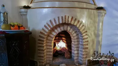 a stone oven with a fire inside of it at Riad Gallery 49 & Spa in Marrakech