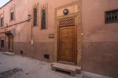 a large wooden door on the side of a building at Riad Dar Attika in Marrakech