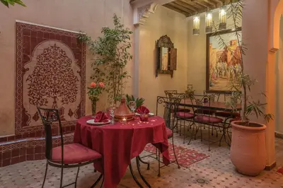 a dining room with a table with a red table cloth at Riad Dar Attika in Marrakech