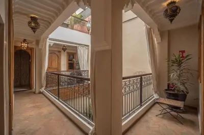 a hallway with a balcony with a potted plant at Riad Dar Attika in Marrakech