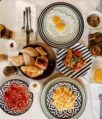 a table with plates of breakfast food on it at Sakkan in Marrakech