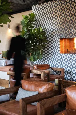 a person walking in a restaurant with a plant at Sakkan in Marrakech