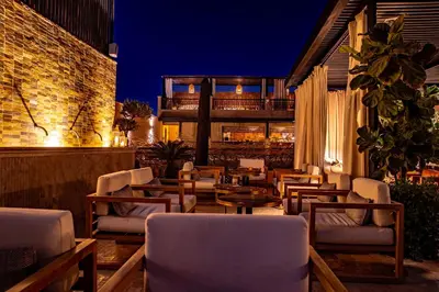 a patio with chairs and tables at night at Sakkan in Marrakech