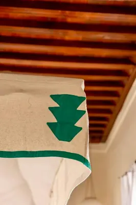 a close up of a green flag on a pillow at Riad Tizwa Marrakech in Marrakech