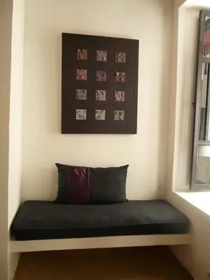 a bench in a room with a picture on the wall at Maison Manzano in Marrakech