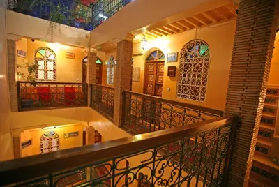 a building with a balcony with stained glass windows at Riad Taghazoute in Marrakech