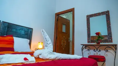 a bedroom with a bed with an animal made out of towels at Riad Taghazoute in Marrakech